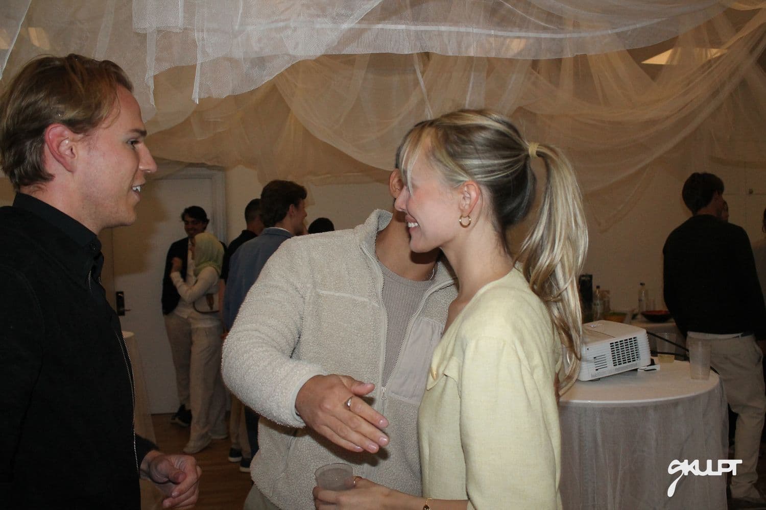 Conversation between guests at a SKULPT gathering