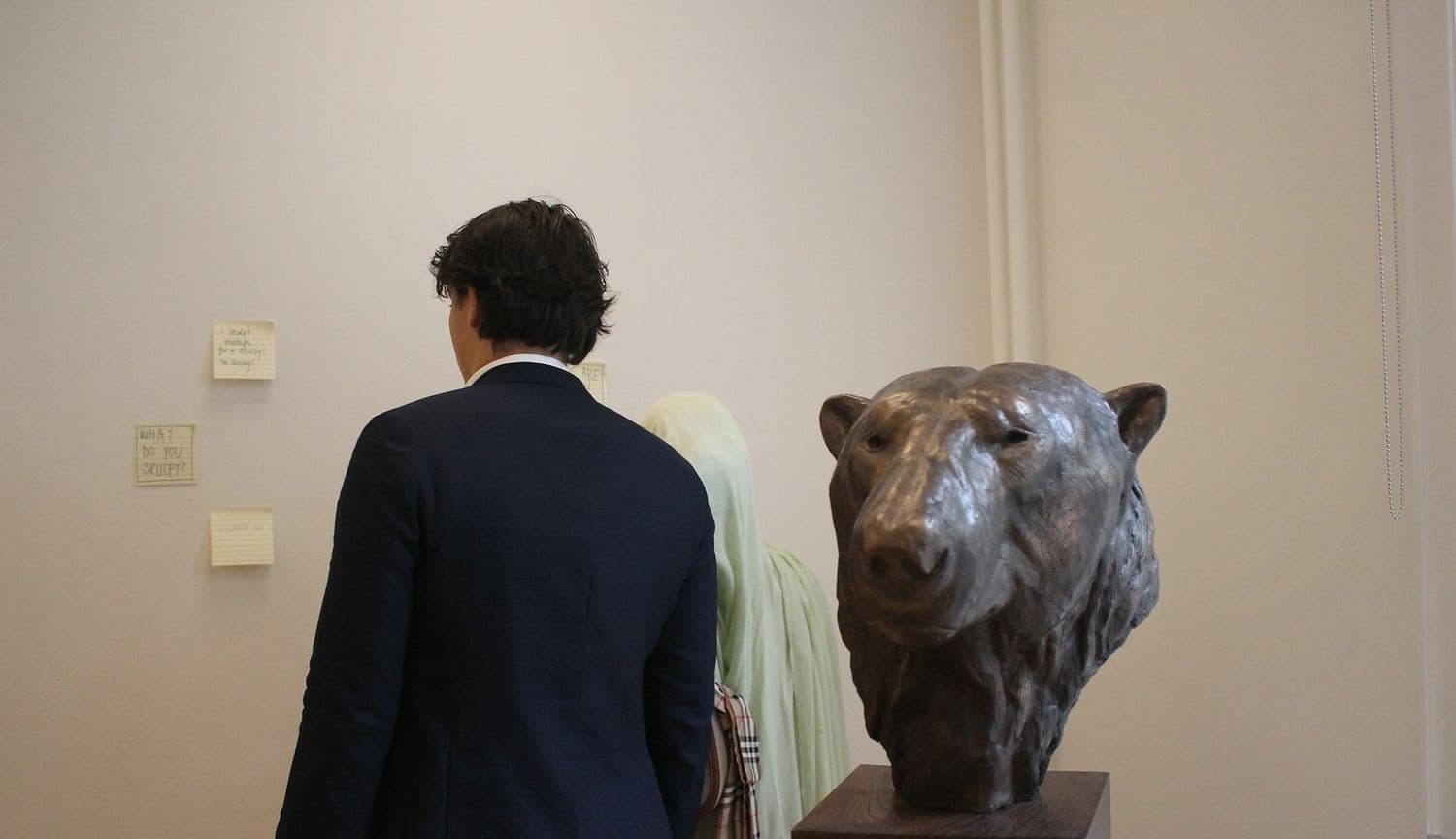 Guest looking at a bronze animal sculpture