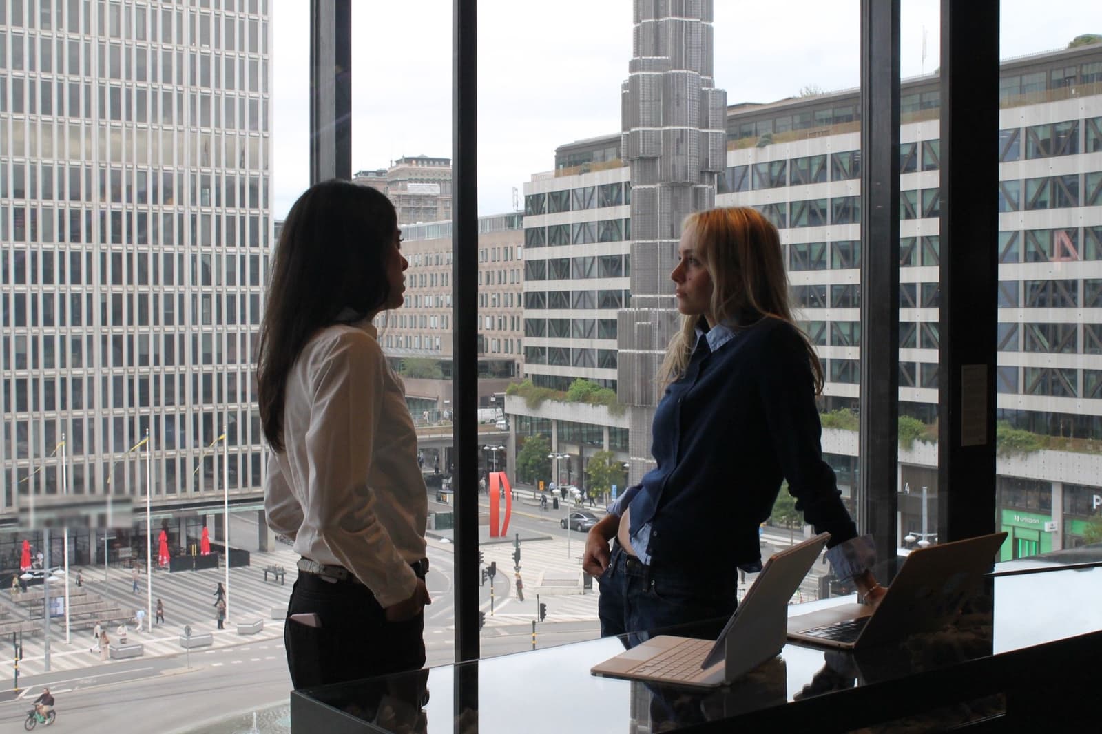 Two startup founders talking by an office window