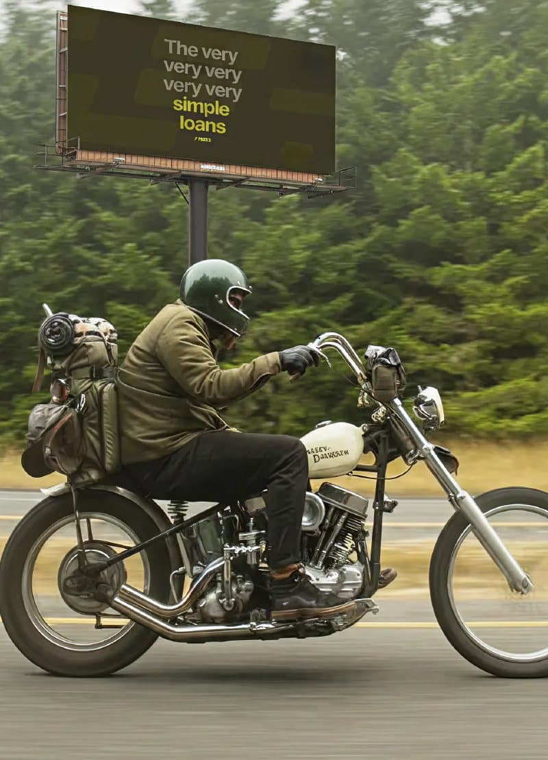 Motorcyclist passing a Finexa billboard