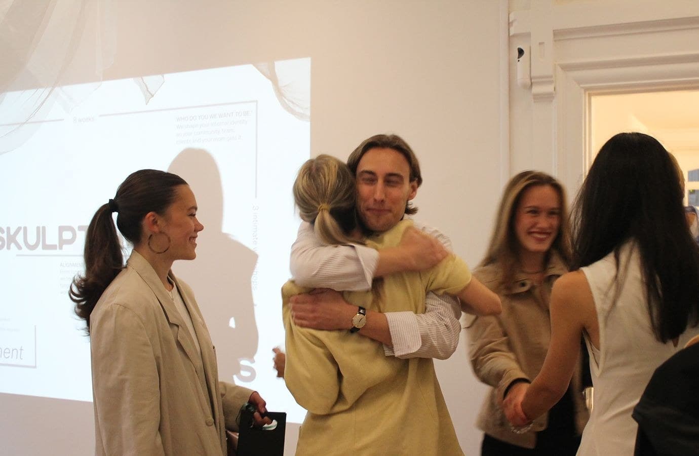 SKULPT Circle members hugging at an event