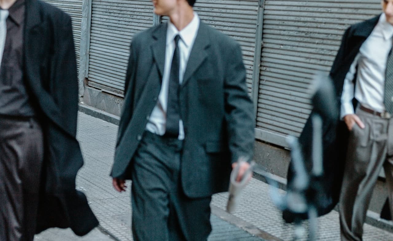 Business people in suits walking down a street